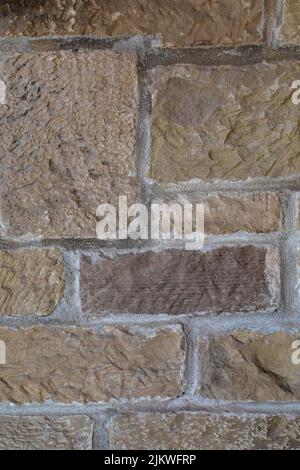 A vertical shot of a brick wall that can be used as a wallpaper or a background Stock Photo