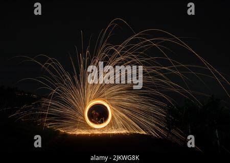 A close-up shot of a light art in the dark. Stock Photo