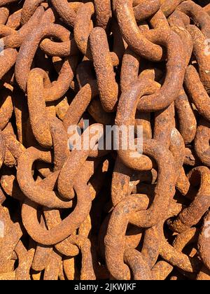 Large rusty metal chains on quay Stock Photo