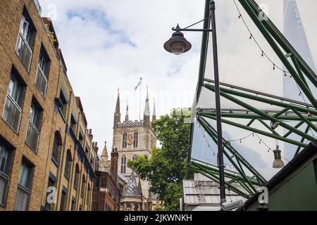 Reflections of The Shard on Borough Market frame the Southwark Cathedral in central London seen in August 2022. Stock Photo