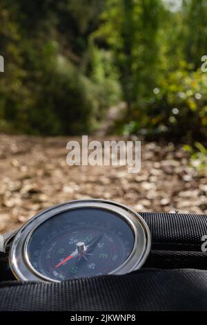 close-up of a compass on a backpack on a hiking day in the mountains Stock Photo