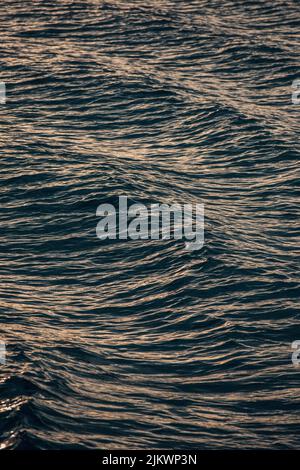 Blue calm sea waves under the sunlight Stock Photo