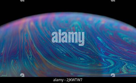 A part of colorful soap bubble isolated on black background Stock Photo