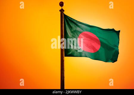 A digital illustration of the flag of Bangladesh waving against a bright yellow sky Stock Photo