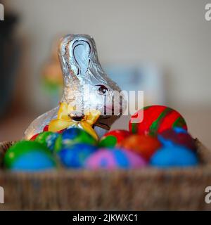 An Easter bunny candy in a basket of Easter eggs Stock Photo