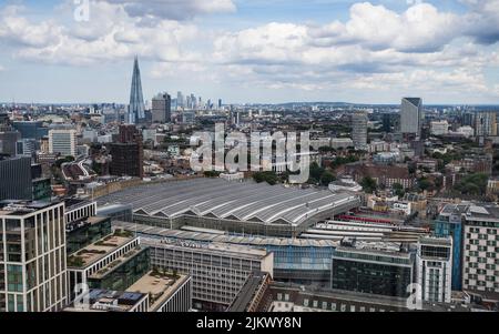 Looking down on Waterloo train station from the London Eye in August 2022.  The Shard and further back still Canary Wharf can be seen in the backgroun Stock Photo