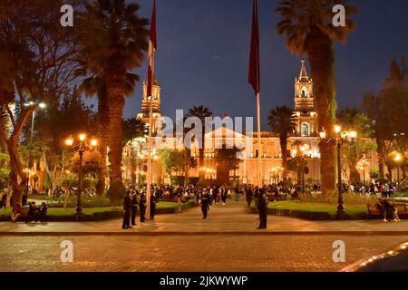 The people strolling in the Main square against the Cathedral of Arequipa in Peru at night Stock Photo