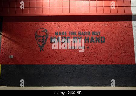 Augusta, Ga USA - 10 18 21: Kentucky Fried Chicken restaurant at night branding art on wall Stock Photo