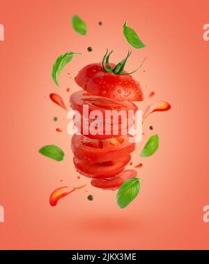 Flying sliced tomato with flowing splashes and basil leaves on red background. Stock Photo