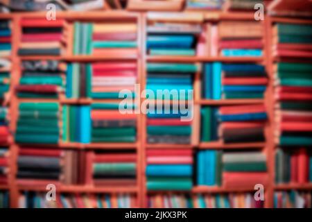 Blurred background from a library with lots of books on the shelves. Education and learning concept Stock Photo