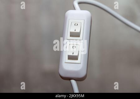 New double plastic switch for desk lamp connected to wire on grey background Stock Photo