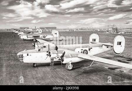 American heavy bombers, Consolidated B-24 Liberator GR Mark IIIs of No. 120 Squadron RAF, lined up with other aircraft at Aldergrove, County Antrim, Northern Ireland. The Mark IIIs are equipped with ASV Mark II anti-submarine radar, while the third aircraft in line, a GR Mark V of No. 86 Squadron RAF carries centrimetric ASV radar in a radome under the nose. Stock Photo