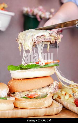 A beautiful shot of two hamburgers with a huge piece of meat and cheese Stock Photo