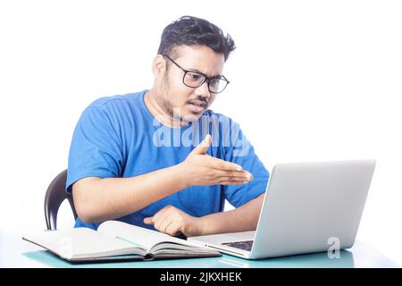 angry expression man talking over video calling on laptop Stock Photo