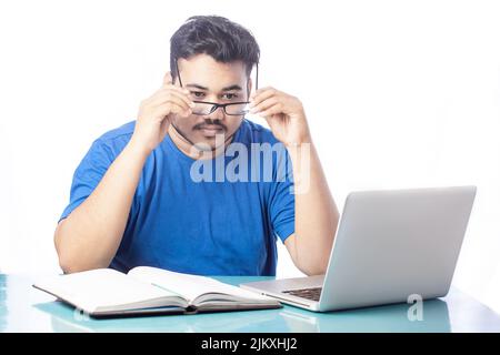 young business man wearing eyeglass while using computer Stock Photo