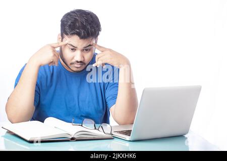 man having headache by working on laptop Stock Photo
