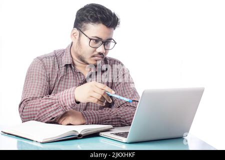 business man pointing pen towards laptop screen in white background Stock Photo