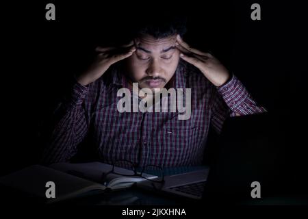 student feeling sick and tired after studying at mid night Stock Photo