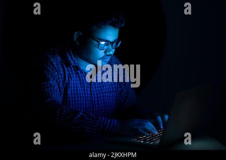 hacker typing programming code at late night Stock Photo