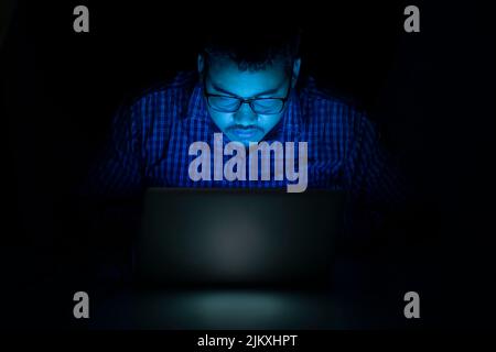 hacker using laptop at night Stock Photo