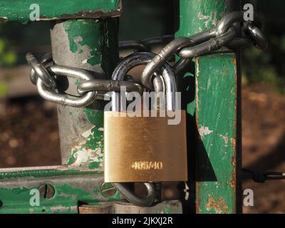 Metal Chain Lock on a green old metal door makro Stock Photo
