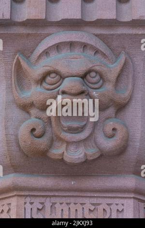 An architectural detail of a keystone above an arch, showing a green man carving. Stock Photo