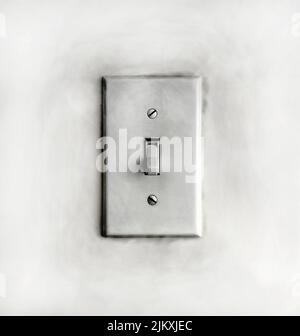 A closeup of a grungy dirty old white light switch on a wall Stock Photo