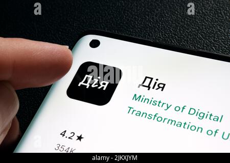 DIia app on smartphone screen. Ukrainian words seen on photo translate as "Action", "Action app". "Diia" app is the State in Smartphone project. Staff Stock Photo