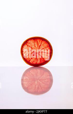 Slice of grapefruit cutaway isolated on white background. Close-up Stock Photo