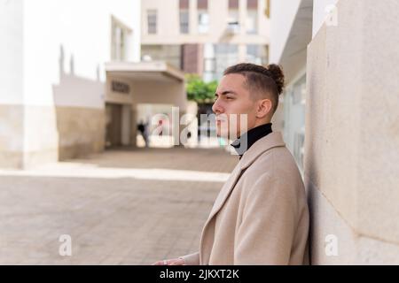 Portrait of a young mixed-race man with a pensive look in the city Stock Photo