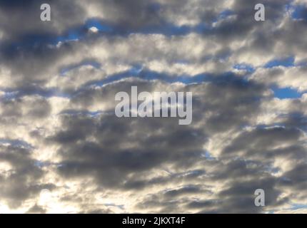 Dramatic Sunburst in White and Grey Clouds Stock Photo