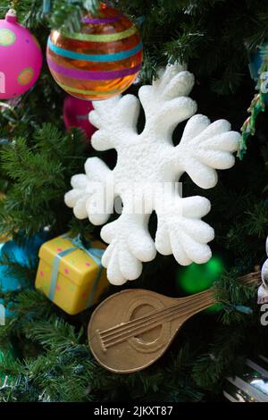 A vertical shot of colorful Christmas balls and ornaments hanging on a tree branches Stock Photo
