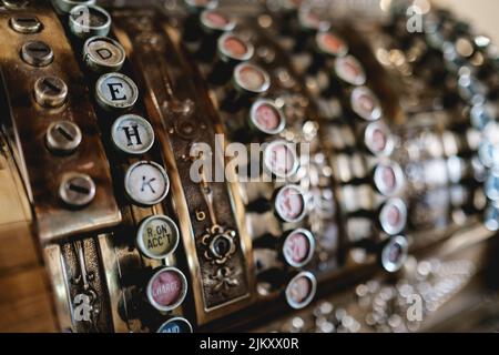 A closeup shot of an old school typewriter on a blurred background Stock Photo