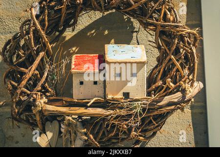A closeup shot of a bird's nest hanging from a wall Stock Photo