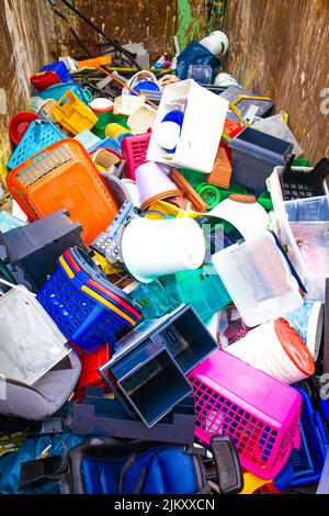 Plastic.Recycling of garbage, plastic products. Old broken things in a container Stock Photo