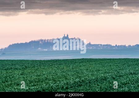 A green landscape with buildings in the background, Sankt Annaberg, Upper Silesia, Poland Stock Photo