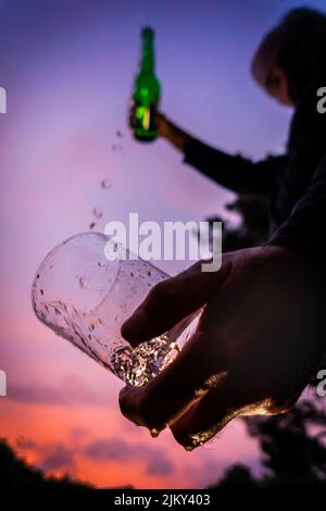 A low angle shot of a man pouring a beer in a glass Stock Photo