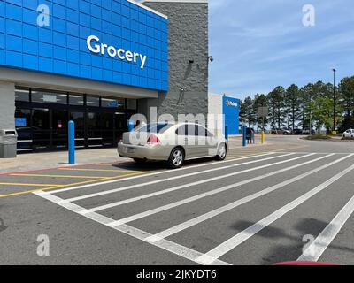 Grovetown, Ga USA - 04 20 22: Walmart retail store entrance people and cars Stock Photo