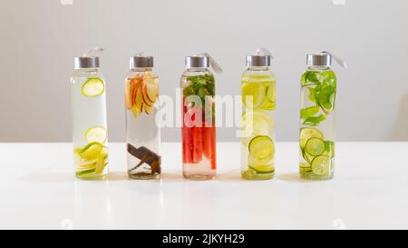 The fresh drinks in small bottles on white table Stock Photo