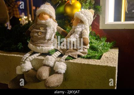 A closeup shot of a couple of dolls on Christmas Stock Photo