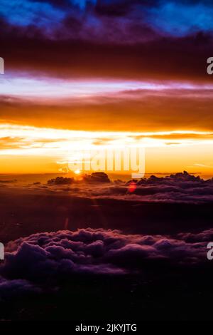 A vertical shot of dramatic sky with clouds during sunset Stock Photo