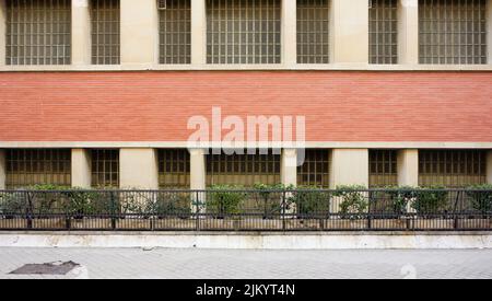 building facade with vertical and horizontal lines of red brick and goometric shapes Stock Photo