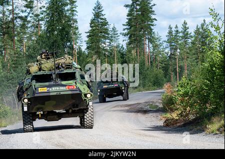 Finnish soldiers with the Pori Brigade readiness unit maneuver in Sisu XA-180 armored personnel carriers during Vigilant Fox, a joint exercise that also included U.S. Soldiers with the 4th Squadron, 10th Cavalry Regiment, 3rd Armored Brigade Combat Team, 4th Infantry Division, and British soldiers from the 2nd Battalion, Rifles Regiment, at Niinisalo, Finland, July 28, 2022. The 3/4th ABCT is among other units assigned to the 1st Infantry Division, proudly working alongside NATO allies and regional security partners to provide combat-credible forces to V Corps, America's forward deployed corps Stock Photo