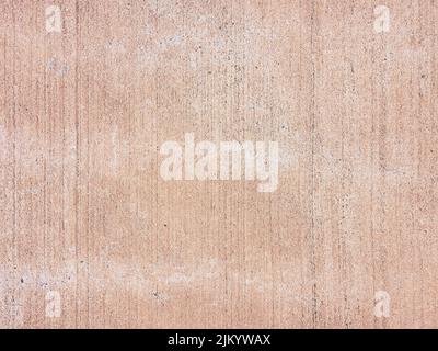A closeup of a grungy rough brown concrete weathered wall texture Stock Photo