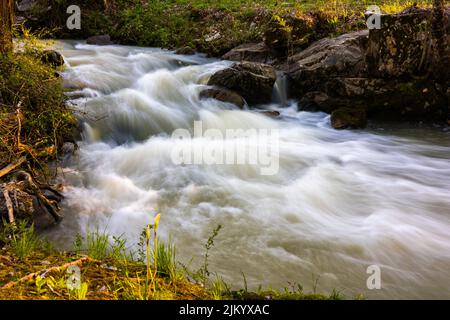 A blurred waterfall in a local creek Stock Photo