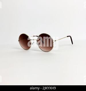 Stylish, modern round-shaped sunglasses isolated on a white background Stock Photo