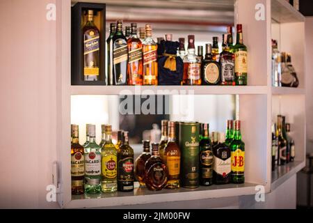 Different alcohol bottle on the shelf of a restaurant bar Stock Photo