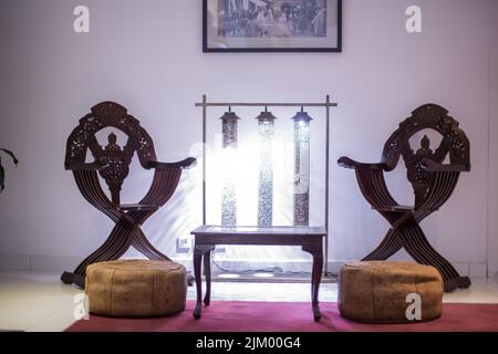 Wooden table with two wooden armchairs next to it in a hotel Stock Photo