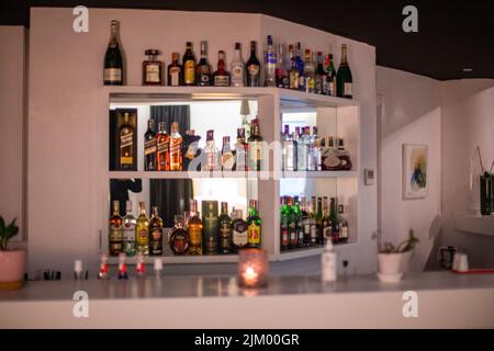 Different alcohol bottle on the shelf of a restaurant bar Stock Photo