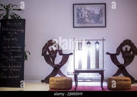 Wooden table with two wooden armchairs next to it in a hotel Stock Photo